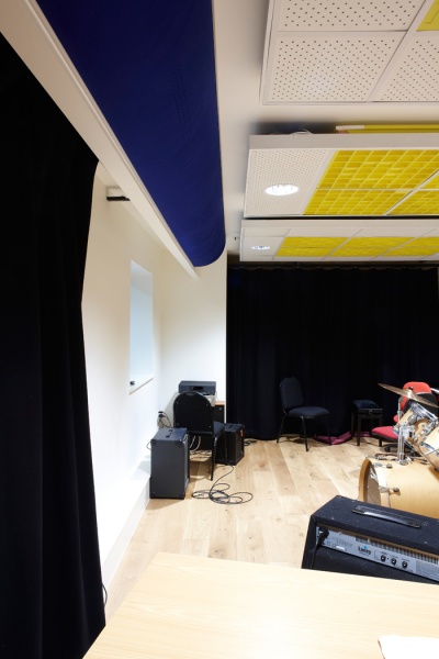 Monkton Combe School
In this practice room there are Diffusors inserted on a suspended ceiling grid with spotlights and Flutterfree T on the walls, this combination of diffusion is to stop unwanted echo in the room without compromising the sounds from the music equipment. MC23.jpg