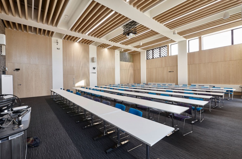 Our team designed and manufactured a range of acoustic products to compliment the design of the new Pavilion building and lecture theatres and classrooms at the newly built Clifton Campus at Nottingham Trent University.
Main Lecture Theatres No. 1,2,& 3:
Lambri acoustic timber slotted panelling in Blond Ash finish was installed on the walls incorporating vent grills, with custom made ceiling fins consisting of Lambri Blond Ash over acoustic absorption.
Photos by Adam Coupe Photography NTH1.jpg