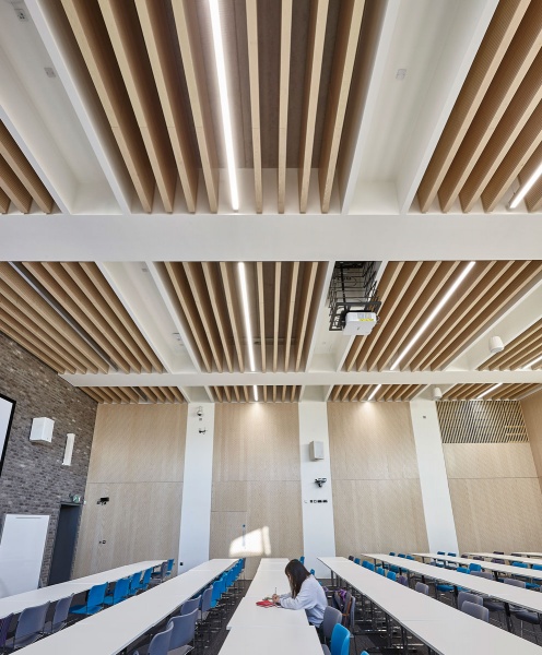 Our team designed and manufactured a range of acoustic products to compliment the design of the new Pavilion building and lecture theatres and classrooms at the newly built Clifton Campus at Nottingham Trent University.
Main Lecture Theatres No. 1,2,& 3:
Lambri acoustic timber slotted panelling in Blond Ash finish was installed on the walls incorporating vent grills, with custom made ceiling fins consisting of Lambri Blond Ash over acoustic absorption.
Photos: Adam Coupe Photography NTH17.jpg