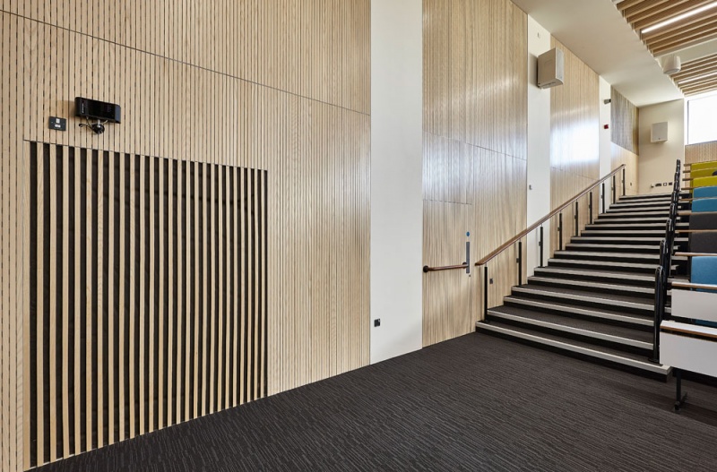 Our team designed and manufactured a range of acoustic products to compliment the design of the new Pavilion building and lecture theatres and classrooms at the newly built Clifton Campus at Nottingham Trent University.
Main Lecture Theatres No. 1,2,& 3:
Lambri acoustic timber slotted panelling in Blond Ash finish was installed on the walls incorporating vent grills, with custom made ceiling fins consisting of Lambri Blond Ash over acoustic absorption.
Photos: Adam Coupe Photography NTH28.jpg
