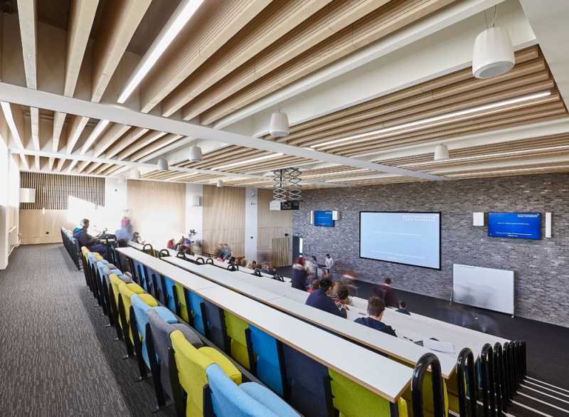 Our team designed and manufactured a range of acoustic products to compliment the design of the new Pavilion building and lecture theatres and classrooms at the newly built Clifton Campus at Nottingham Trent University.
Main Lecture Theatres No. 1,2,& 3:
Lambri acoustic timber slotted panelling in Blond Ash finish was installed on the walls incorporating vent grills, with custom made ceiling fins consisting of Lambri Blond Ash over acoustic absorption.
Photos: Adam Coupe Photography NTH31.jpg
