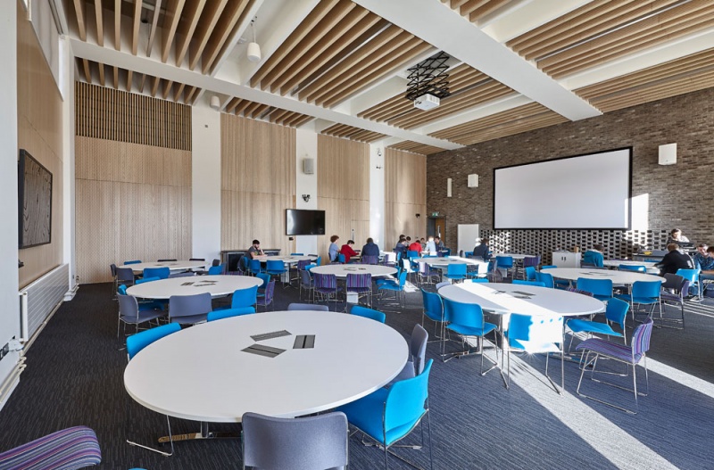 Our team designed and manufactured a range of acoustic products to compliment the design of the new Pavilion building and lecture theatres and classrooms at the newly built Clifton Campus at Nottingham Trent University.
Main Lecture Theatres No. 1,2,& 3:
Lambri acoustic timber slotted panelling in Blond Ash finish was installed on the walls incorporating vent grills, with custom made ceiling fins consisting of Lambri Blond Ash over acoustic absorption.
Photos: Adam Coupe Photography NTH19.jpg
