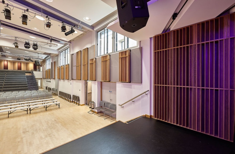 For the side walls, we installed our Soundtrac stretch system with Cara fabric, and fitted bespoke QRD panels finished in Oak on brackets to make them reversible, allowing the user to vary the acoustics of the room.The stage has Oak Diffractals on the side walls, mounted in series to give a seamless appearance to the array.
Photos: Adam Coupe Photography 4.jpg