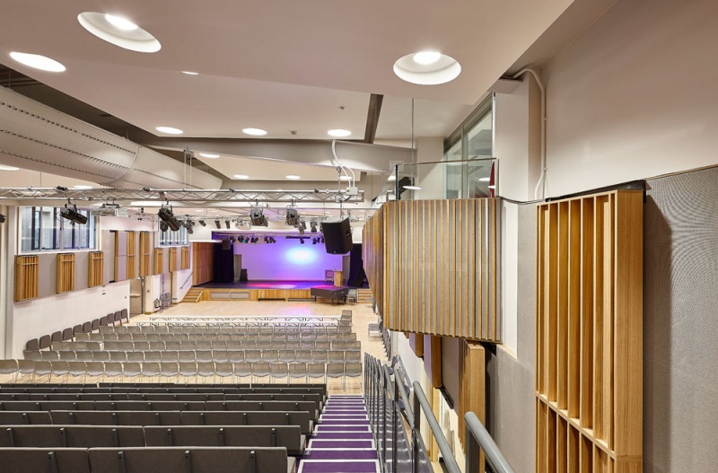 A selection of our acoustic wood products were specified for the new performing arts centre at Putney High School and installed by our team.
For the side walls, we installed our Soundtrac stretch system with Cara fabric, and fitted bespoke QRD panels finished in Oak on brackets to make them reversible, allowing the user to vary the acoustics of the room.
The upper level balconies are clad in our new modular timber panels, 25mm fabric covered panels with real oak strips mounted on the face, factory finished for quick site installation.
Photos: Adam Coupe Photography
7.jpg